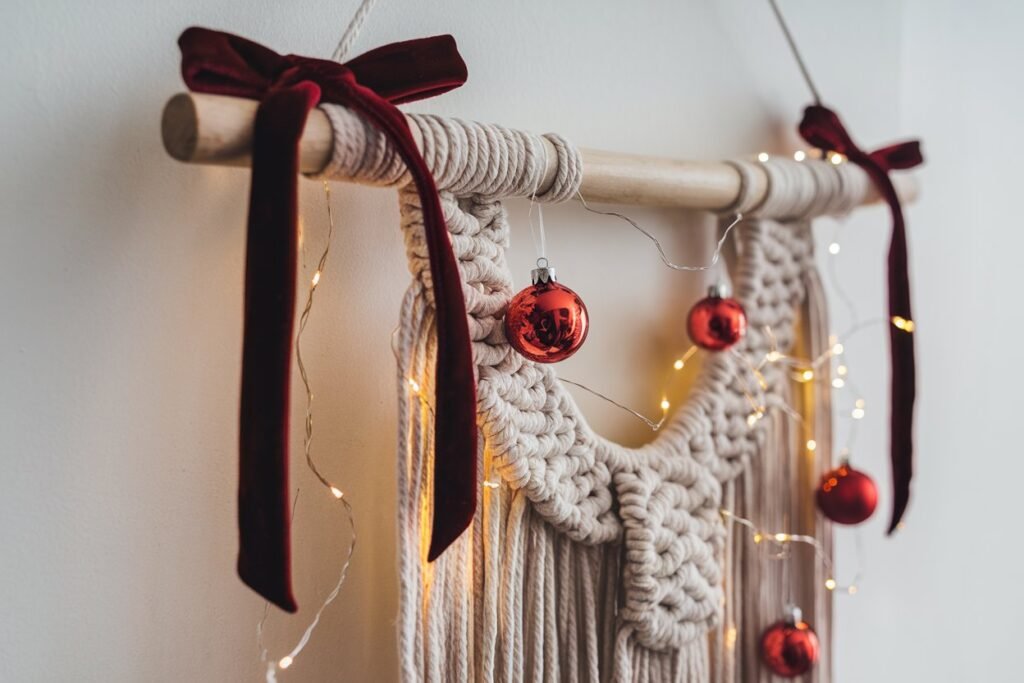  A macramé hanger adorned with fairy lights, mini baubles, and a red velvet ribbon